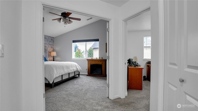 bedroom featuring light carpet, vaulted ceiling, and ceiling fan