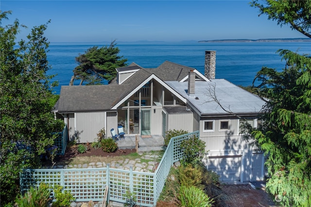 view of front of house featuring a garage and a water view