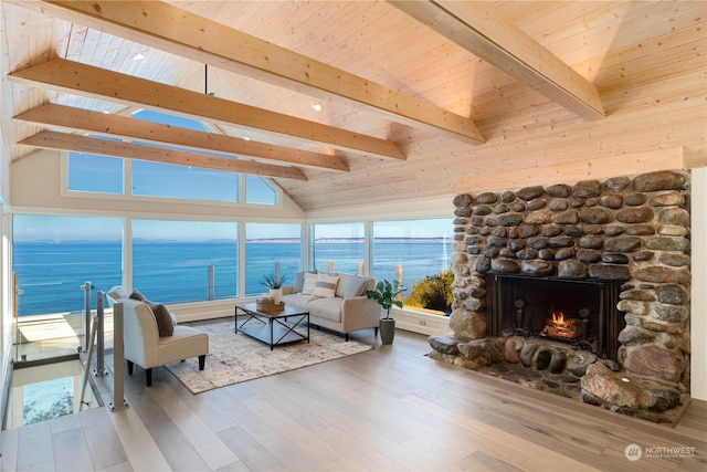 living room featuring a fireplace, hardwood / wood-style floors, wood ceiling, lofted ceiling with beams, and a water view