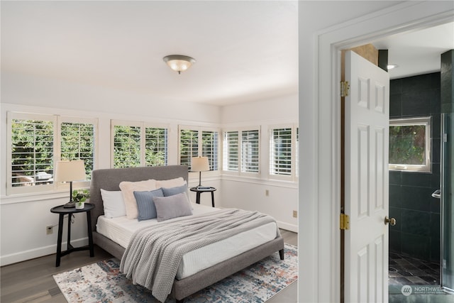 bedroom featuring hardwood / wood-style floors and multiple windows