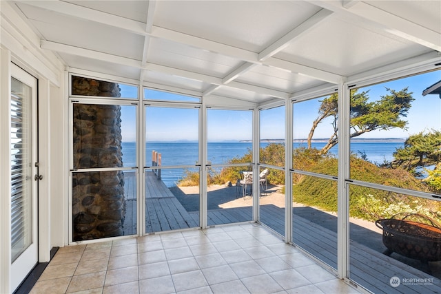 sunroom / solarium featuring coffered ceiling, a water view, beam ceiling, and a wealth of natural light