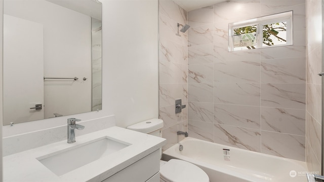 full bathroom featuring toilet, tiled shower / bath combo, and vanity