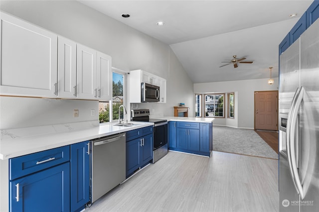 kitchen featuring ceiling fan, stainless steel appliances, blue cabinets, and a healthy amount of sunlight