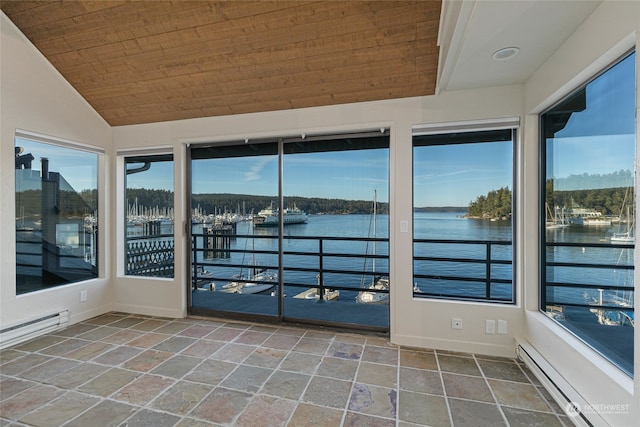 unfurnished sunroom with a baseboard heating unit, vaulted ceiling, and a water view