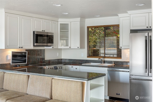 kitchen with crown molding, white cabinetry, stainless steel appliances, kitchen peninsula, and sink