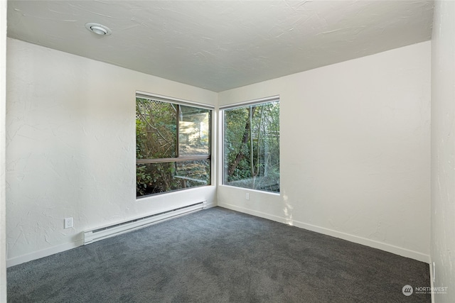 spare room with a textured ceiling, a baseboard radiator, and carpet flooring