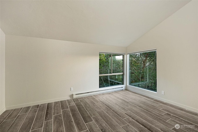 241 Warbass Way Unit A303, Friday Harbor, WA 98250 - spare room with a baseboard heating unit, dark wood-type flooring, and lofted ceiling