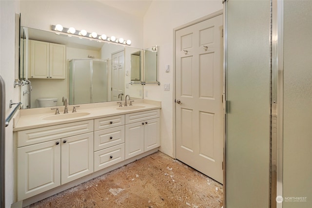 bathroom with vanity, toilet, hardwood / wood-style flooring, and a shower with door