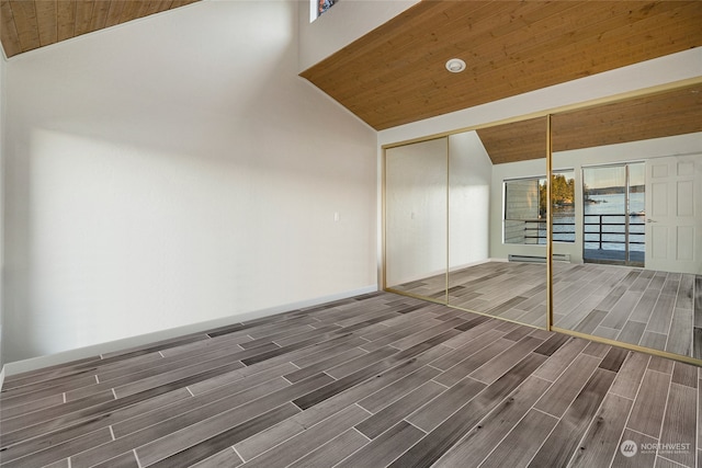 unfurnished room featuring dark wood-type flooring, baseboard heating, high vaulted ceiling, and wooden ceiling