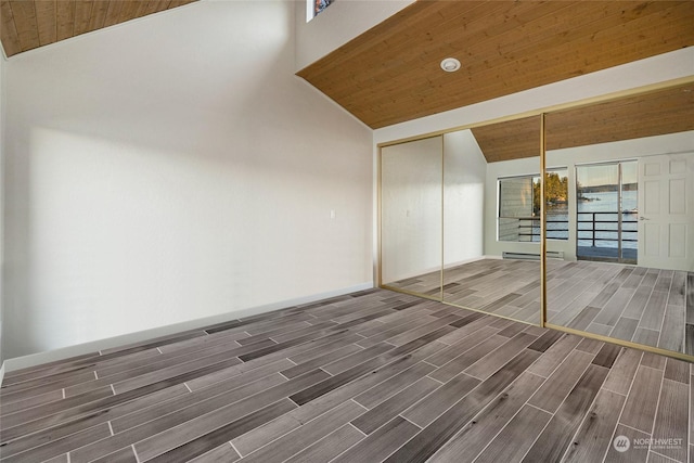 241 Warbass Way Unit A303, Friday Harbor, WA 98250 - unfurnished bedroom with lofted ceiling, wood finish floors, wooden ceiling, and a closet