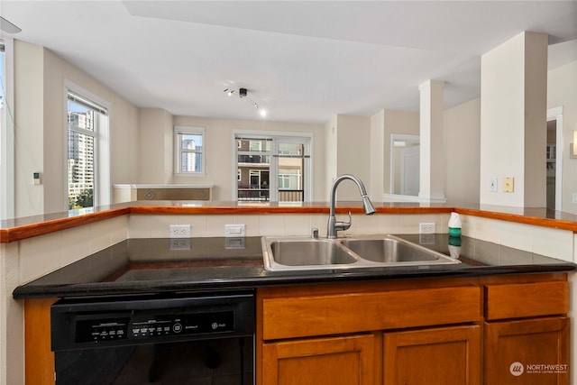 kitchen featuring backsplash, dishwasher, kitchen peninsula, and sink