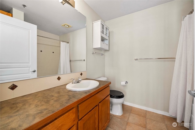 bathroom featuring tile patterned flooring, vanity, and toilet