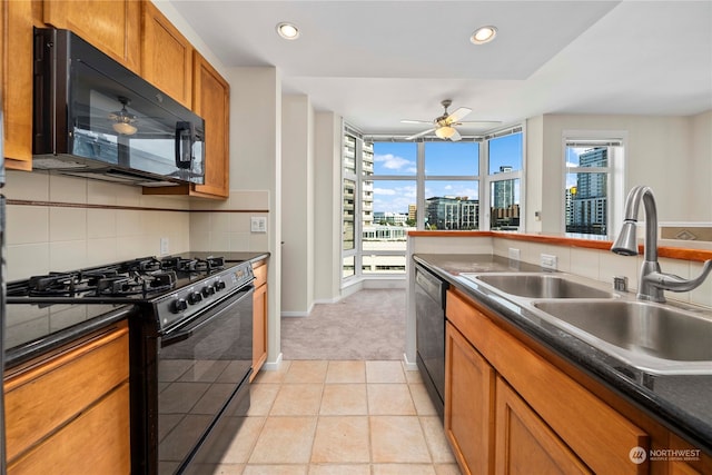 kitchen with light carpet, backsplash, black appliances, sink, and ceiling fan