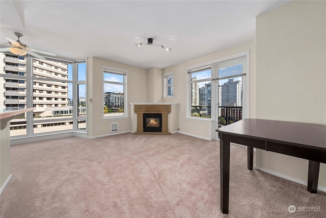 interior space with a wealth of natural light and ceiling fan