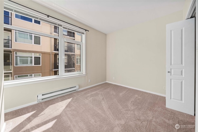 unfurnished room featuring carpet flooring and a baseboard radiator