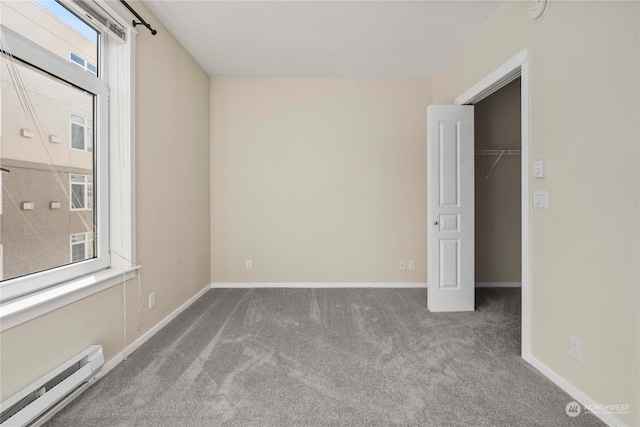 carpeted empty room with a baseboard radiator