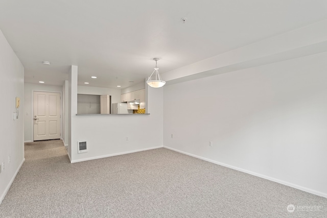 unfurnished living room with light carpet