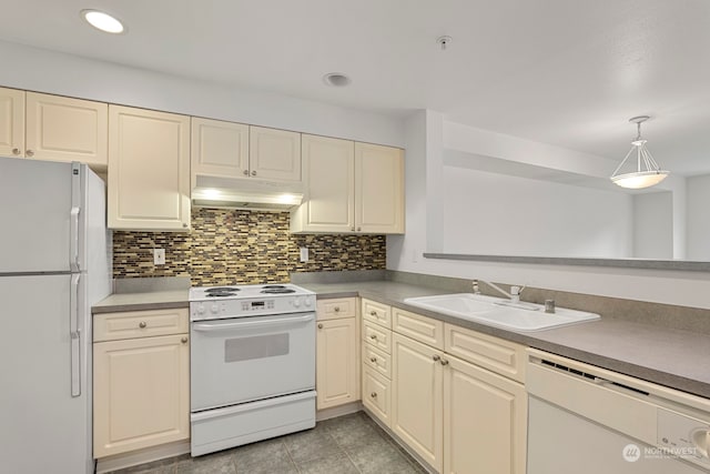 kitchen with white appliances, pendant lighting, backsplash, sink, and light tile patterned flooring