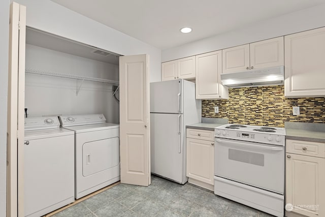 kitchen with separate washer and dryer, white appliances, white cabinetry, and tasteful backsplash