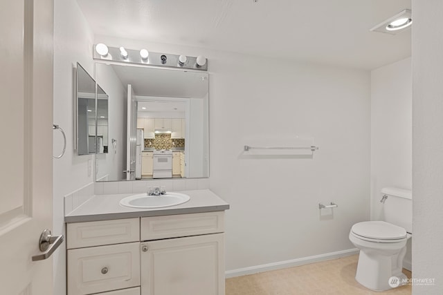 bathroom featuring backsplash, toilet, and vanity