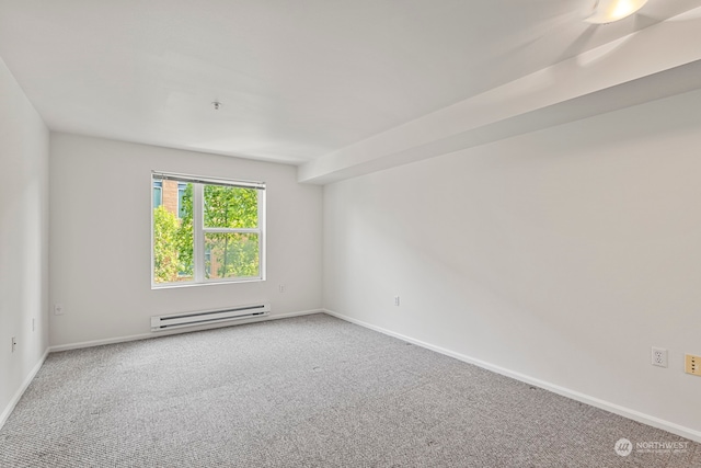 carpeted spare room featuring baseboard heating