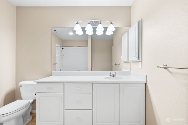 bathroom featuring toilet, walk in shower, vanity, and tile patterned flooring