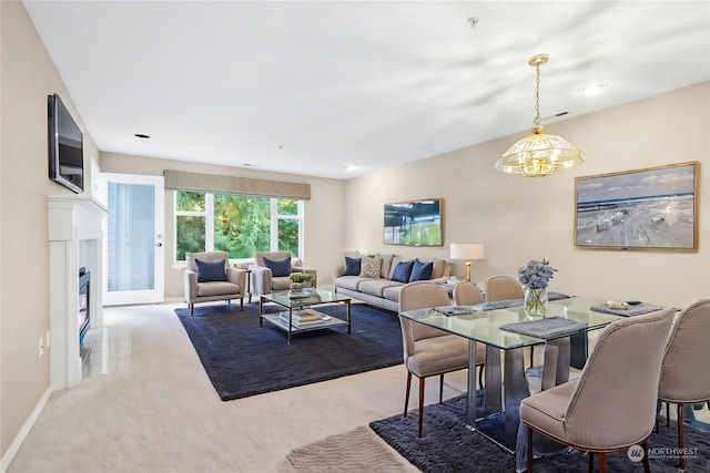 carpeted dining space with an inviting chandelier