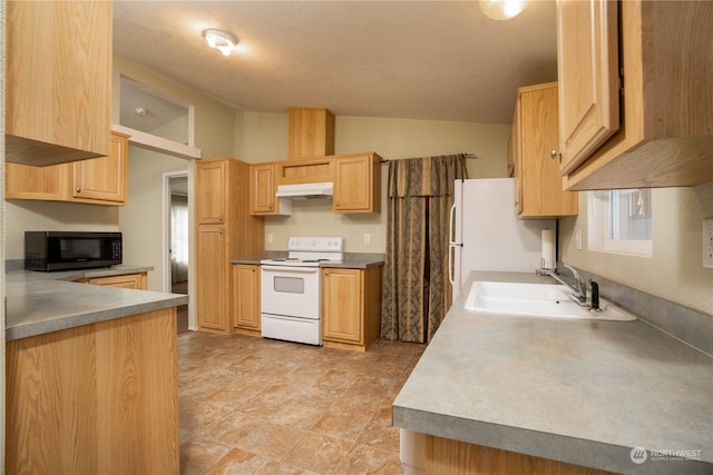 kitchen featuring a textured ceiling, sink, light brown cabinets, and white appliances