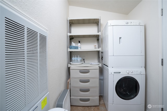 laundry area featuring stacked washer and dryer