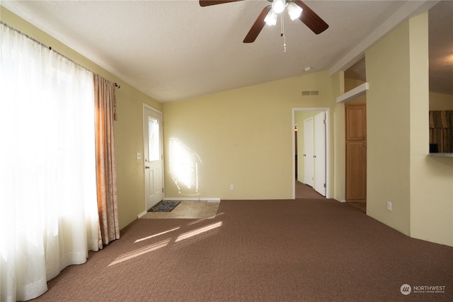 unfurnished room featuring lofted ceiling, ceiling fan, and carpet floors