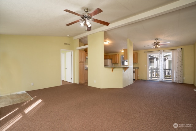 unfurnished living room featuring lofted ceiling with beams, ceiling fan, and carpet floors