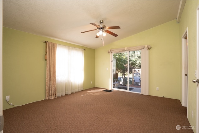 empty room featuring vaulted ceiling, a textured ceiling, ceiling fan, and carpet flooring