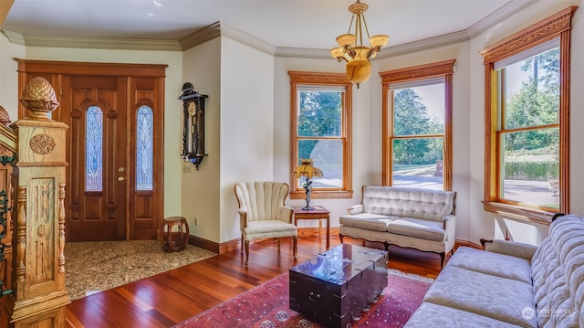 living room featuring ornamental molding, wood-type flooring, and a notable chandelier