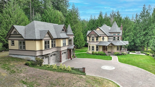 view of front of property featuring a garage and a front lawn