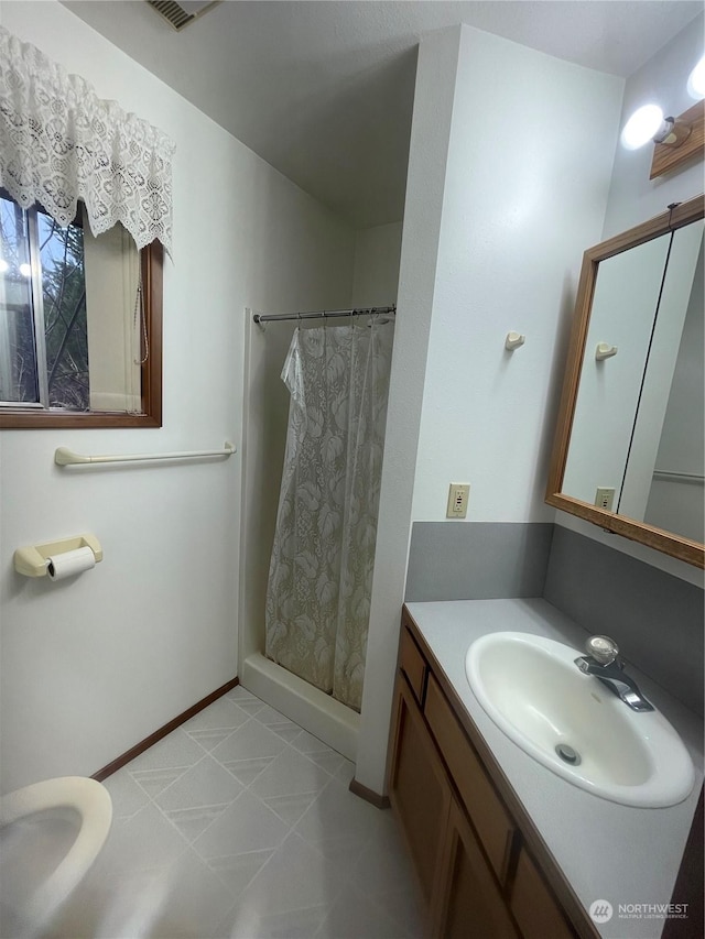 bathroom with vanity and curtained shower