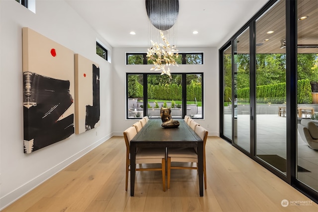 dining space featuring plenty of natural light, a chandelier, and light hardwood / wood-style floors