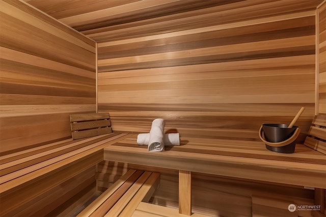 view of sauna featuring wooden walls