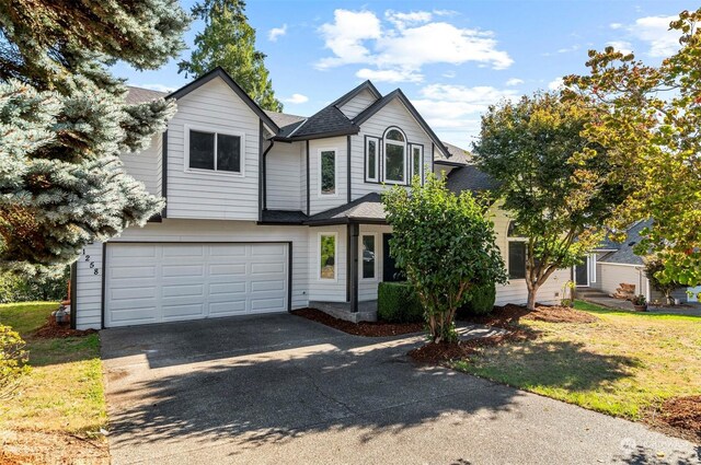 view of front of home with a garage and a front yard