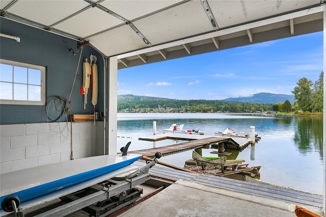 view of dock featuring a water and mountain view