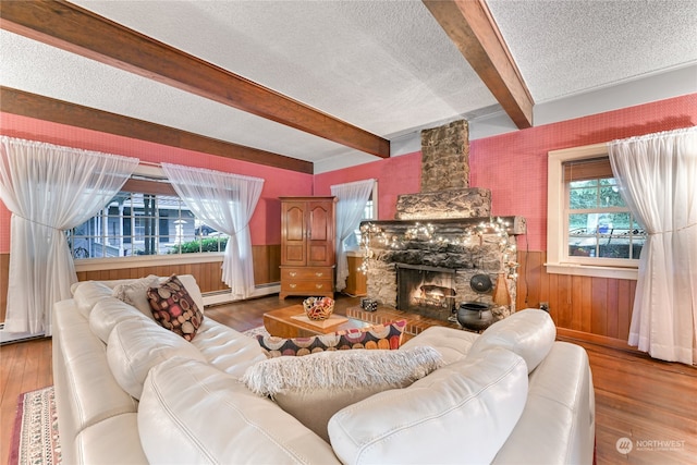 living room featuring a textured ceiling, plenty of natural light, and wood-type flooring