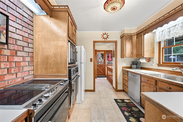 kitchen with crown molding, brick wall, stainless steel appliances, and sink