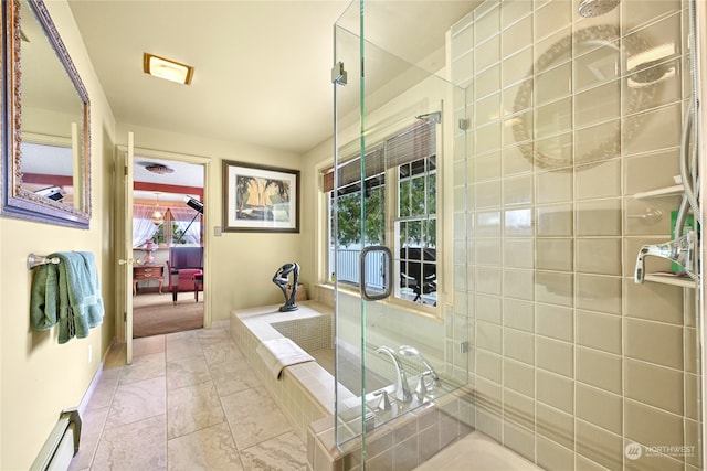 bathroom with shower with separate bathtub and baseboard heating