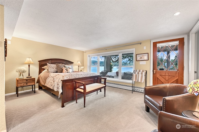 bedroom featuring a textured ceiling, a baseboard radiator, light colored carpet, and a water view