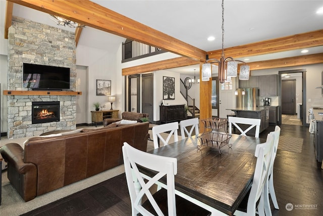 73 Sweet Shop Ln, Cle Elum, WA 98922 - dining space with beam ceiling, a notable chandelier, recessed lighting, dark wood-type flooring, and a stone fireplace