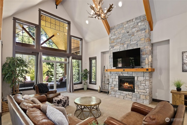 73 Sweet Shop Ln, Cle Elum, WA 98922 - carpeted living area featuring baseboards, high vaulted ceiling, a stone fireplace, and a notable chandelier