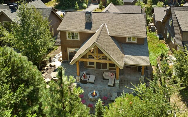 73 Sweet Shop Ln, Cle Elum, WA 98922 - rear view of property with roof with shingles, a chimney, an outdoor fire pit, central AC, and a patio area