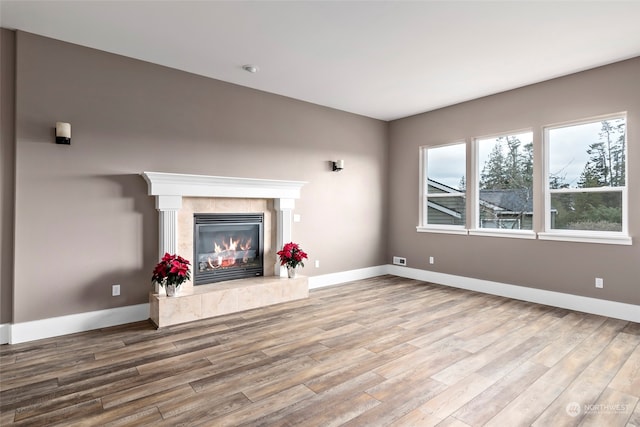 unfurnished living room featuring hardwood / wood-style floors and a fireplace