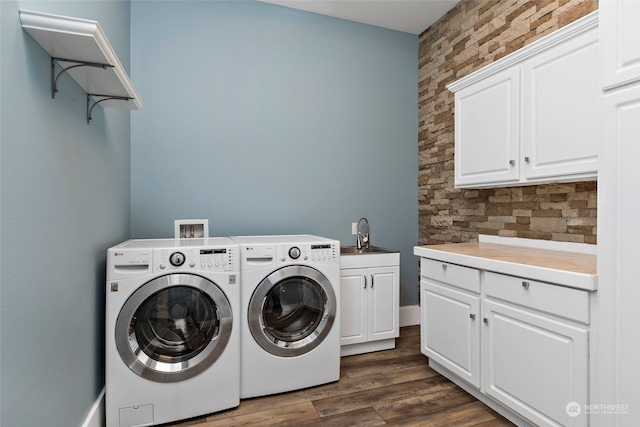 washroom with separate washer and dryer, dark hardwood / wood-style flooring, cabinets, and sink