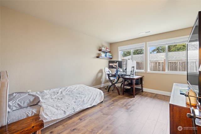 bedroom with wood-type flooring