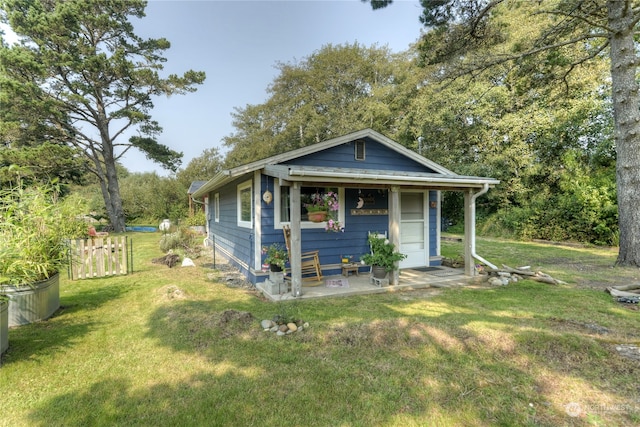 bungalow-style home with a front lawn